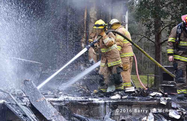 firefighters overhaul after doublewide trailer fire