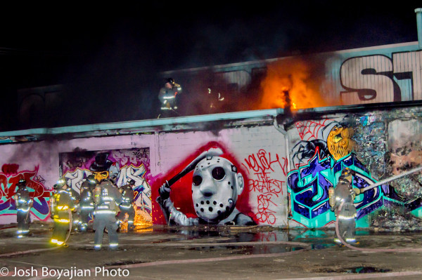 graffiti covered building on fire
