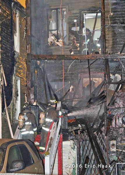 firemen overhaul back porches fire in Chicago