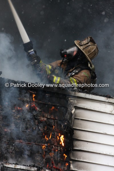firefighter with PPE mask and hose line