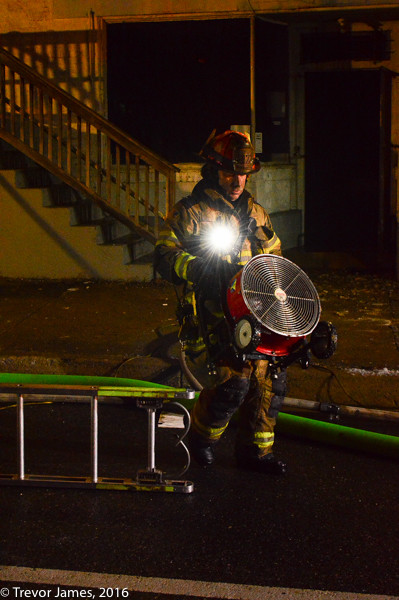 firefighter carrying a fan