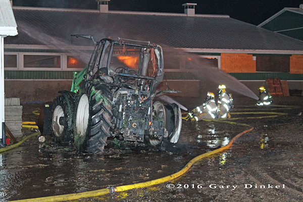 tractor destroyed by fire with barn