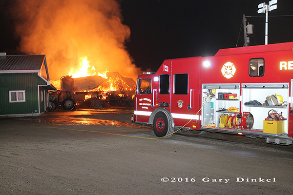 dairy barn fully engulfed in flames at night