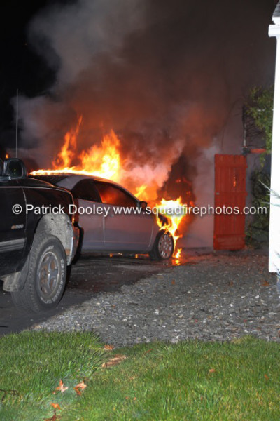 car and garage burn at night