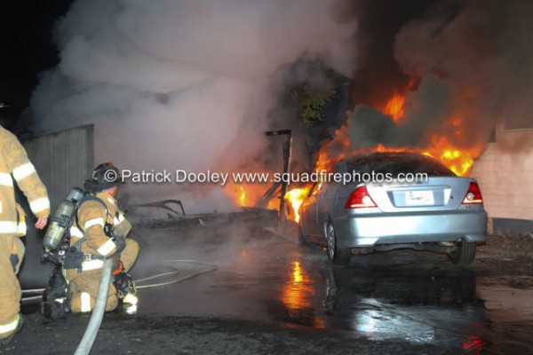 firemen battle garage fire at night