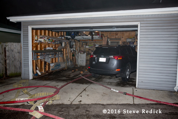 fire hose deployed through alley garage
