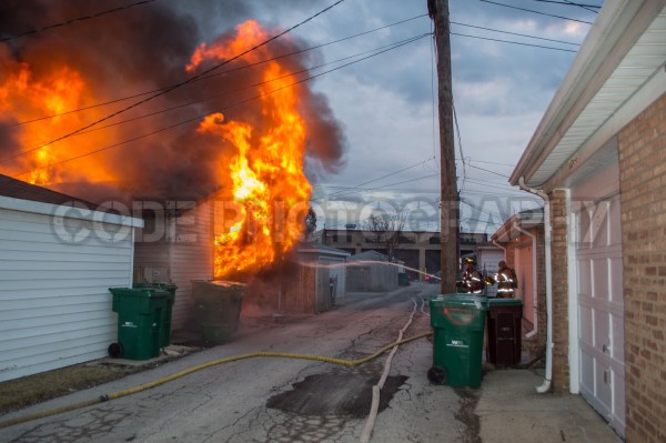 alley garage engulfed in flames