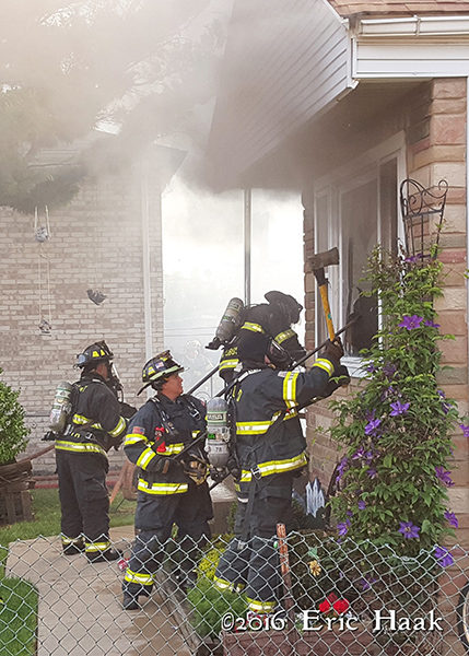 firemen vent house by breaking windows