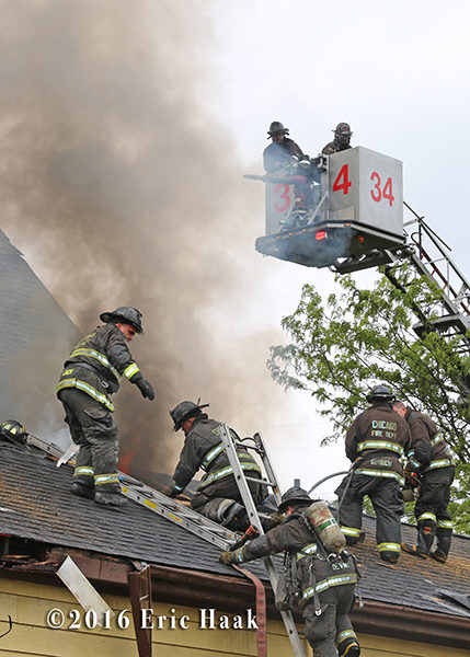 firefighters vent roof during house fire