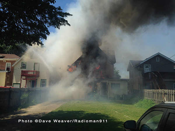 heavy smoke and flames from house fire