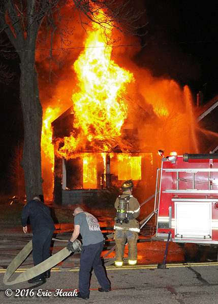 firefighters at fully engulfed house fire