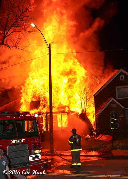 firefighter at fully engulfed house fire