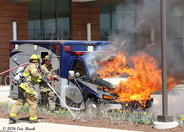 firemen battle an ambulance destroyed buy fire