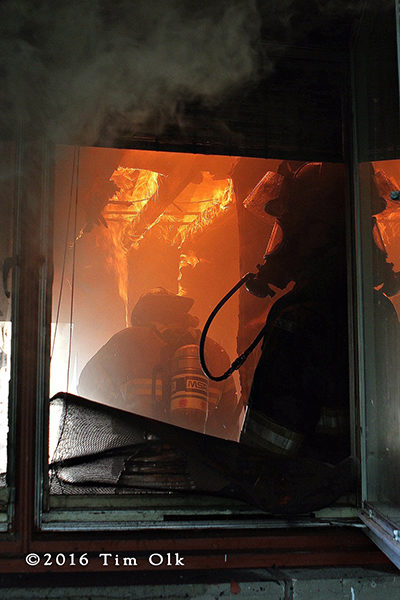 firefighters in kitchen with fire overhead