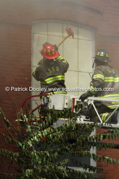 firefighters vent window from aerial ladder