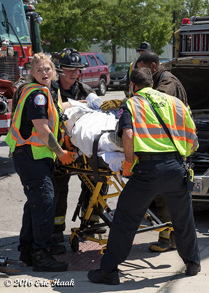 paramedics move accident victim on stretcher