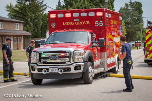 Long Grove FD ambulance drives over fire hose