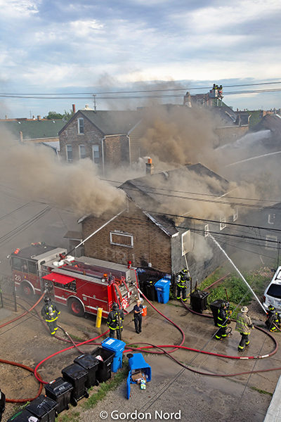 deck gun from fire engine in use during house fire