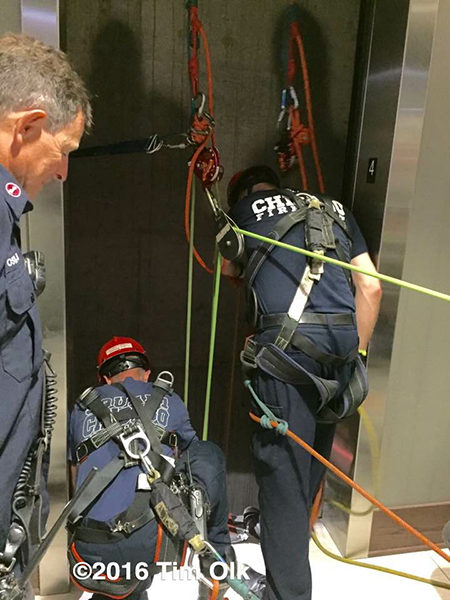 firefighters rescue trapped victims in an elevator