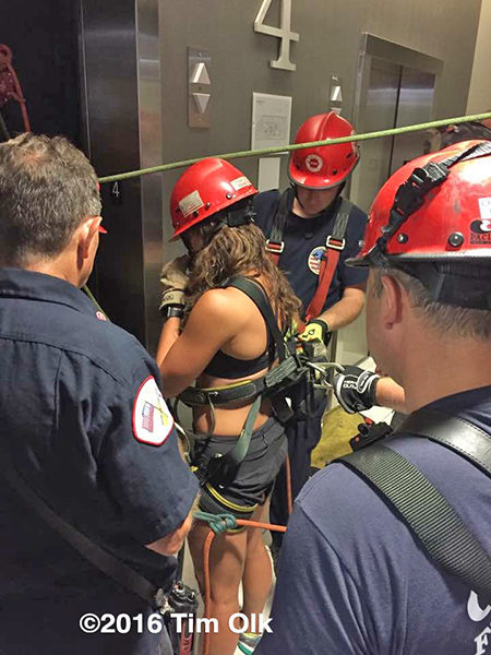 firefighters rescue trapped victims in an elevator