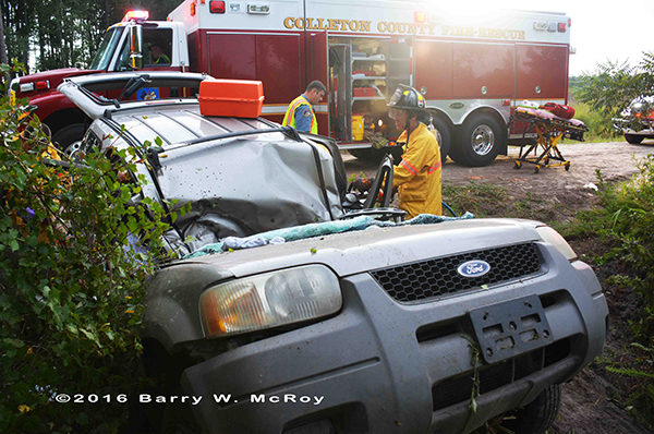 firefighters extricate driver trapped in car