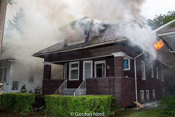 heavy smoke and flames from Chicago style bungalow