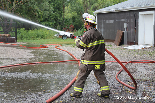 firefighter with hose line at fire