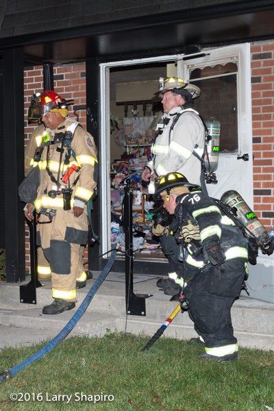 firefighters at door of townhouse fire