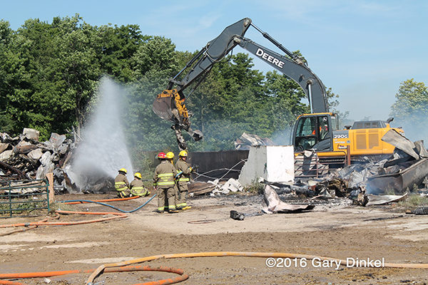 excavator assists firefighters after barn fire