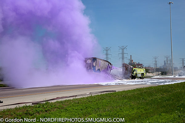 CFD airport crash truck at semi crash on a highway discharging purple K