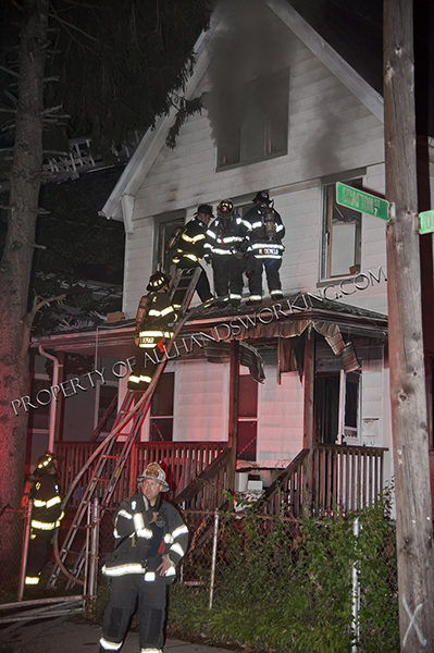 firefighters enter window during night house fire