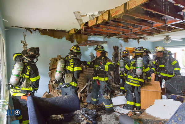 firefighters overhaul house after fire