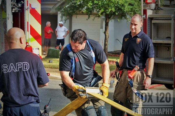 firefighters drain hose after fire
