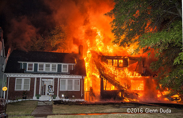 vacant house fully engulfed in flames at night spreads to other house