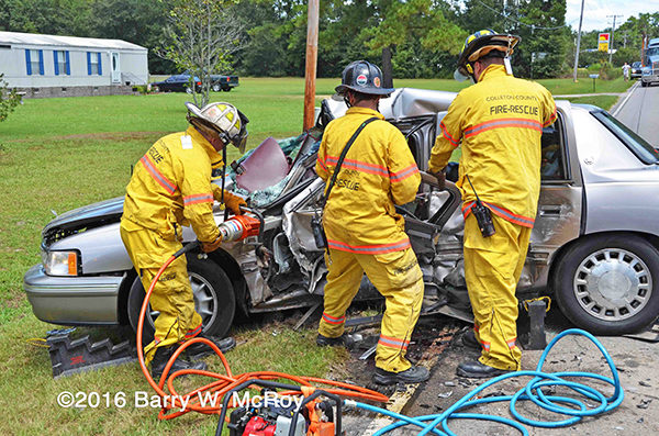 firefighters use Holmatro tools to cut driver from car