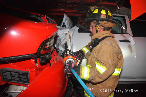 firefighter uses Holmatro tools to cut driver from car