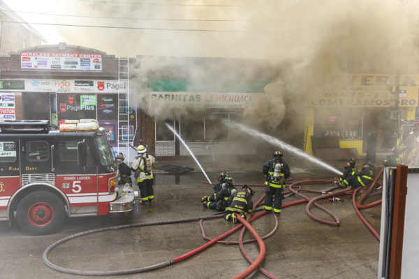 firefighters battle commercial fire