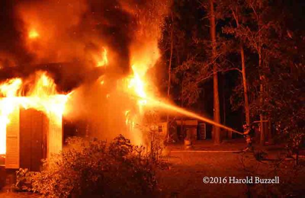 firefighters battle mobile home fire at night