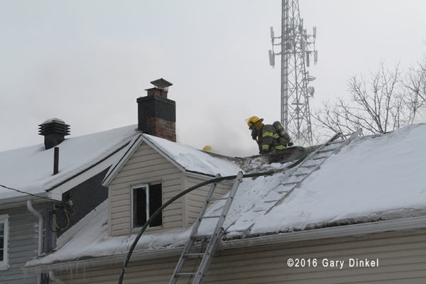firefighter on roof with snow