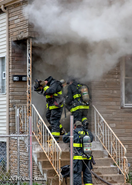 Firefighters prepare to enter burning house