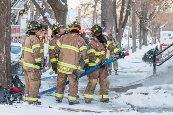 firefighters in freezing cold at fire scene