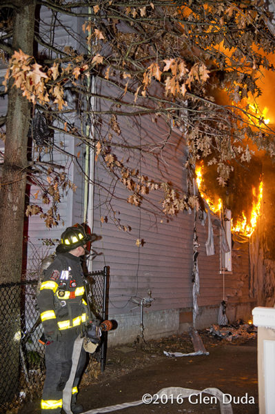 firefighter waits for water at house fire