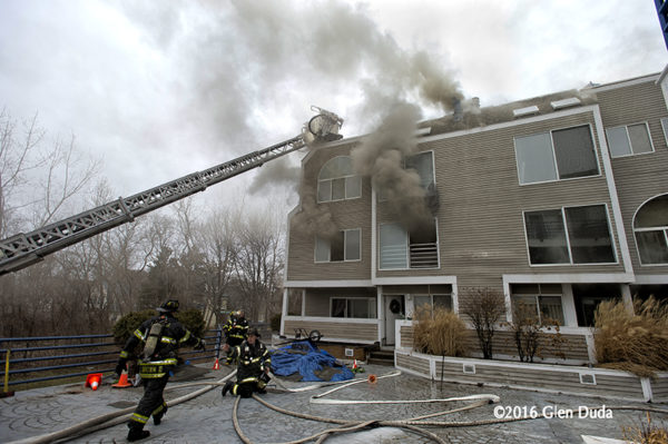 firefighters battle fire in a condo building