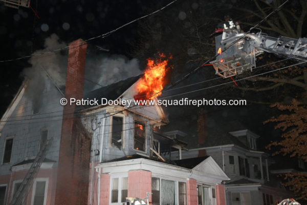 smoke and flames from house attic at night