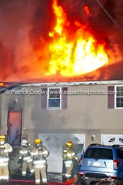 flames through the roof of a house