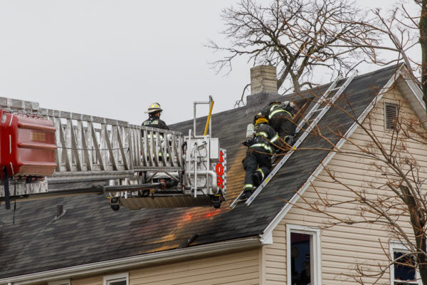 firefighters vent roof after house fire