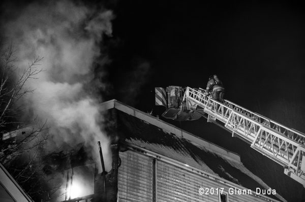 firefighters in tower ladder platform at fire