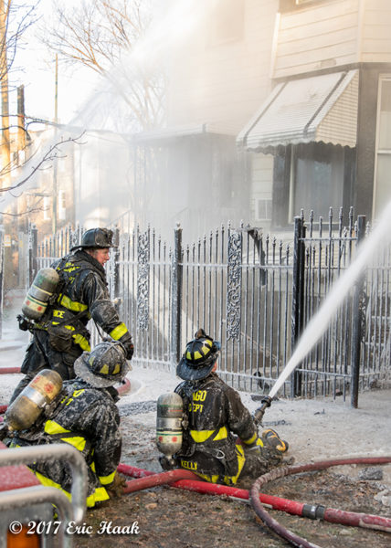 firefighters covered with ice battling a fire