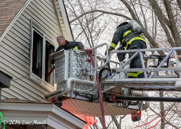 firefighters work from tower ladder