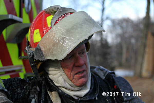 firefighter with helmet coated with ice